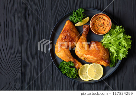 fried chicken legs with lettuce, lemon on plate 117824299