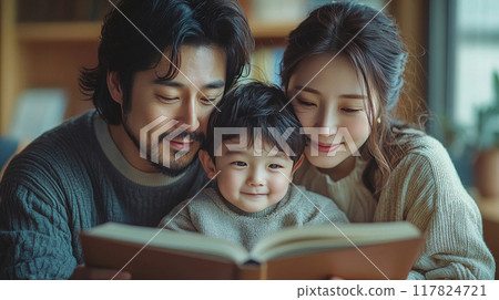 Portrait of a happy asian family father mother and son reading education book together at home. 117824721
