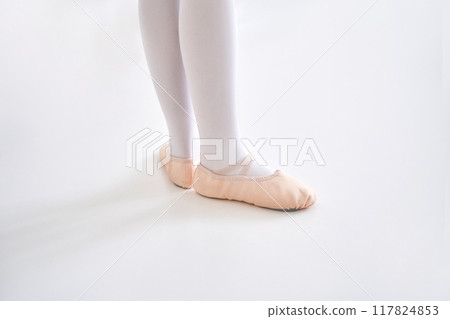 Young ballet girl at studio lesson. Training performance. Stretching exercise Young ballet girl at studio lesson. Training performance. Stretching exercise 117824853