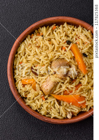 Delicious fresh pilaf with rice, carrots, meat, onions, spices and berries Delicious fresh pilaf with rice, carrots, meat, onions, spices and berries 117825368