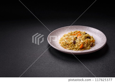 Delicious fresh pilaf with rice, carrots, meat, onions, spices and berries 117825377