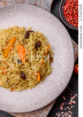 Delicious fresh pilaf with rice, carrots, meat, onions, spices and berries 117825385