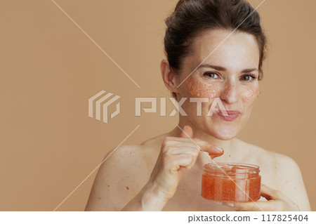 smiling modern female with face scrub smiling modern female with face scrub 117825404