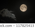 The moon is in the night sky with clouds. Full moon 117825413