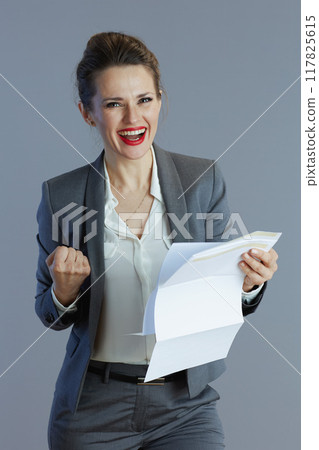 smiling trendy woman worker against gray background 117825615