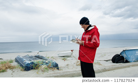 Man Taking Notes At The Sea  117827024