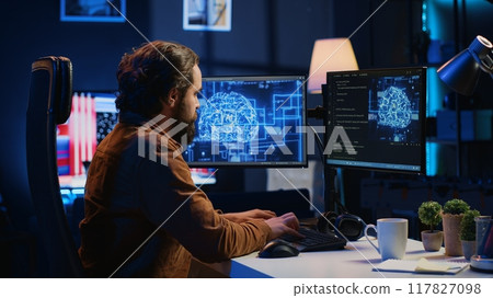 Software developer writes code on multimonitor setup PC to visualize artificial intelligence neural networks. Teleworking IT employee runs AI script on computer from home office, camera A 117827098