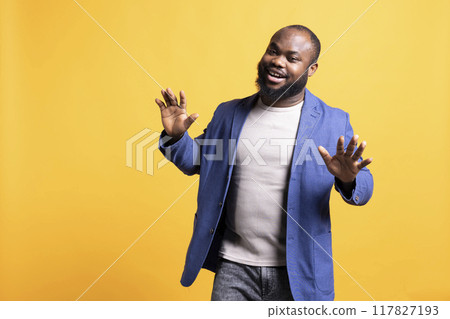 Portrait of fresh sharp african american man exuding self assurance, isolated over studio background. Expressive carefree BIPOC person looking dapper, posing nonchalantly and smiling Portrait of fresh sharp african american man exuding self assurance, isolated over studio background. Expressive carefree BIPOC person looking dapper, posing nonchalantly and smiling 117827193