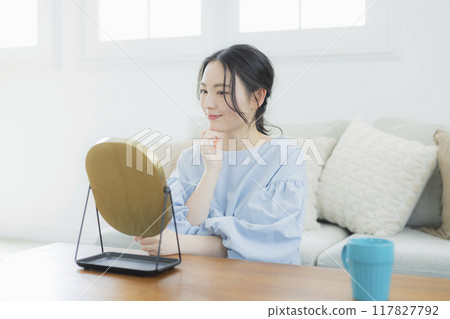 A young woman concerned about her skin condition 117827792