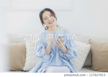 Young woman looking at a smartphone 117827813