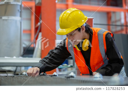 Male workers wear red helmet working check up iron product in factory. Male workers wear red helmet working check up iron product in factory. 117828253