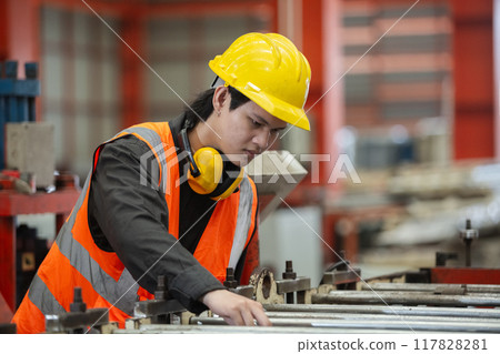 Asian male workers wear red helmet working check up iron production manufacturing 117828281