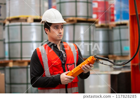 Professional technician engineer factory workers use control remote for controlling 117828285