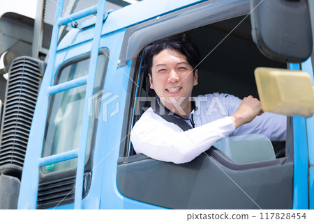 Truck driver sitting in the driver's seat with a smile 117828454