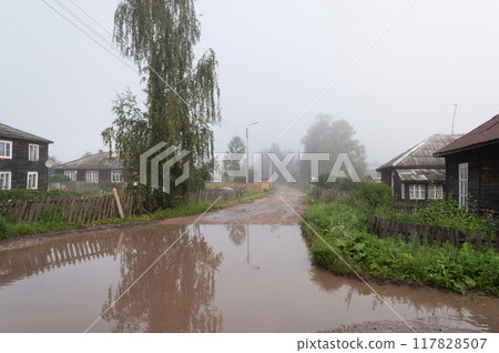Dirt road with big puddle in the village 117828507