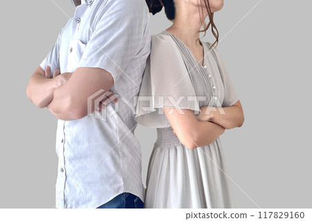 A man and a woman fighting with their backs turned 117829160