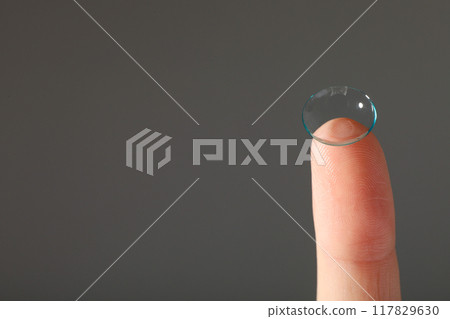 Close-up of a clear contact lens on a fingertip Close-up of a clear contact lens on a fingertip 117829630