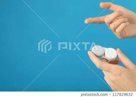 Container for lenses and contact lens in hand 117829632