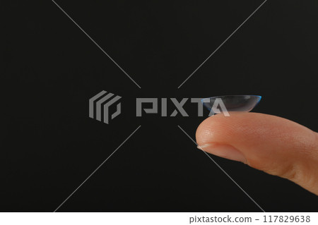 Close-up of a clear contact lens on a fingertip Close-up of a clear contact lens on a fingertip 117829638