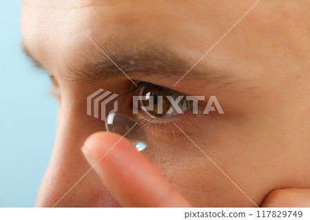 Installation of a contact lens in the eye close-up 117829749