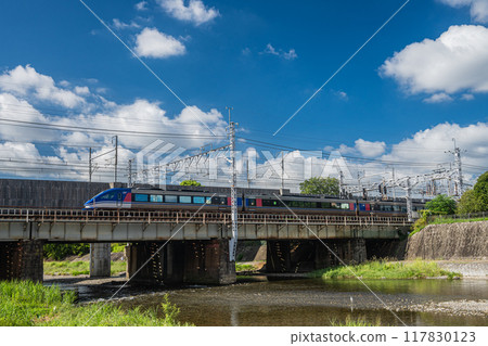Super Hakuto express train stops on a siding above a railway bridge Super Hakuto express train stops on a siding above a railway bridge 117830123
