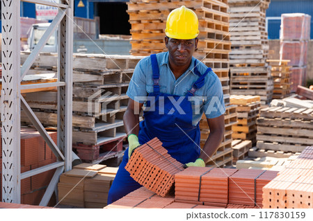 Male worker controlling quantity of ceramic tiles Male worker controlling quantity of ceramic tiles 117830159