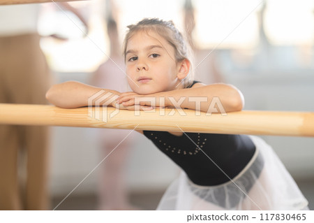 Rest between rehearsals - little ballerina rests during break between ballet lessons Rest between rehearsals - little ballerina rests during break between ballet lessons 117830465