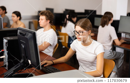 Teenage girl using computer during lesson Teenage girl using computer during lesson 117830679