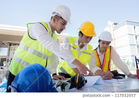 Construction Team Reviewing Project Plans on Site. Coordination and Strategy 117832057