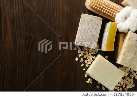 Natural handmade soap with ingredients, on a dark background. Natural handmade soap with ingredients, on a dark background. 117834030