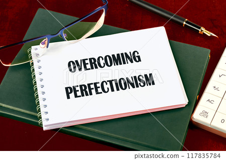 Business Overcoming perfectionism concept. Copy space. Concept words Overcoming perfectionism top view in notepad Business Overcoming perfectionism concept. Copy space. Concept words Overcoming perfectionism top view in notepad 117835784