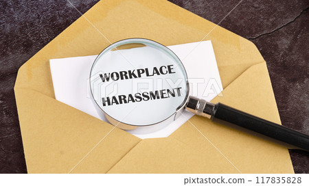 WORKPLACE HARASSMENT written through a magnifying glass in a letter on white paper sticking out of an envelope WORKPLACE HARASSMENT written through a magnifying glass in a letter on white paper sticking out of an envelope 117835828
