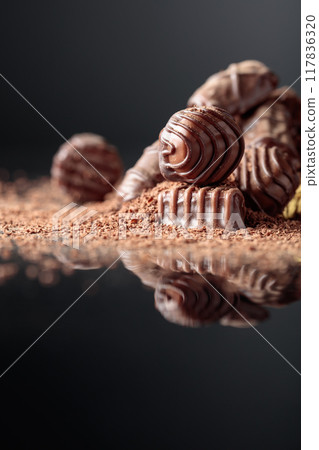 Chocolate candies sprinkled with chocolate chips. 117836320