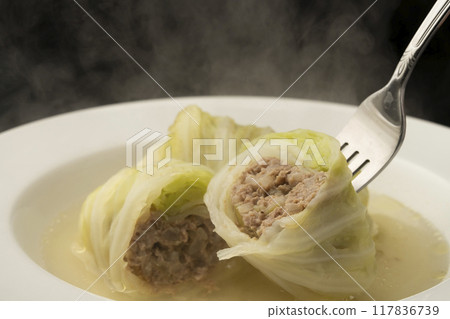 Rolled cabbage: Lift the cabbage rolls with a fork 117836739