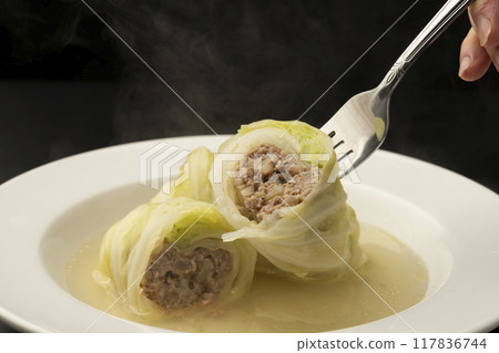 Rolled cabbage: Lift the cabbage rolls with a fork 117836744