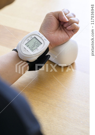 Man measuring blood pressure at home Man measuring blood pressure at home 117836948
