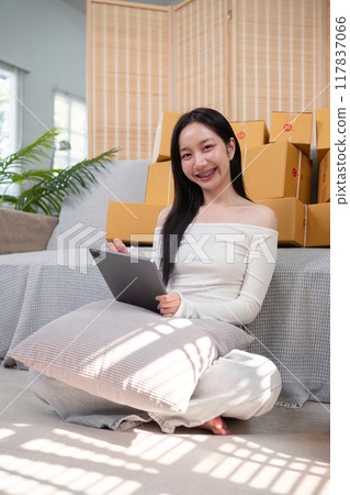 Young Businesswoman Using Tablet for Online Store Management. Ecommerce Efficiency Young Businesswoman Using Tablet for Online Store Management. Ecommerce Efficiency 117837066