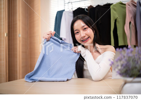 Woman Showcasing Clothing for Online Sale. Ecommerce Fashion Display Woman Showcasing Clothing for Online Sale. Ecommerce Fashion Display 117837070