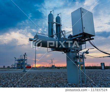 View from the ground of the stem and actuator of an underground gas pipeline valve. Early morning. 117837524