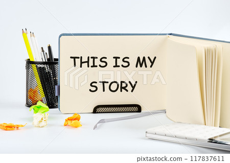 This is my Story, business motivational inspirational quotes concept THIS IS MY STORY on a blank sheet of notepad in the stand 117837611