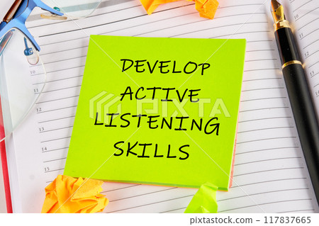 Business and Develop active listening skills concept. DEVELOP ACTIVE LISTENING SKILLS on a green sticker on the background of an open notebook Business and Develop active listening skills concept. DEVELOP ACTIVE LISTENING SKILLS on a green sticker on the background of an open notebook 117837665