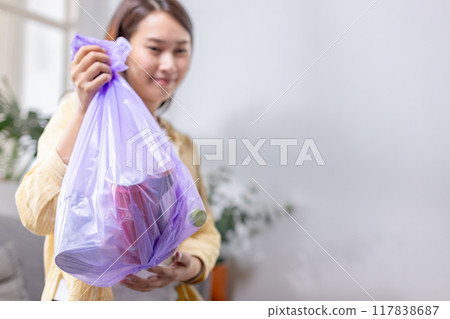 woman is holding bag for sorting garbage. Trash can for Waste sorting in home. 117838687