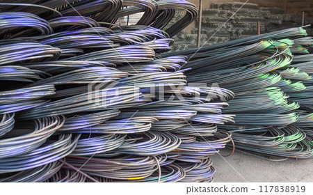 Steel rods or bars used to reinforce concrete, stocked in warehouse. 117838919