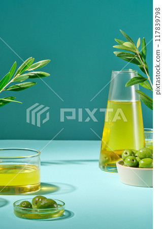 Scene for display of organic natural cosmetic products - empty space with fresh olive bowl and olive oil on green background. Blank space to display packaging mockup Scene for display of organic natural cosmetic products - empty space with fresh olive bowl and olive oil on green background. Blank space to display packaging mockup 117839798
