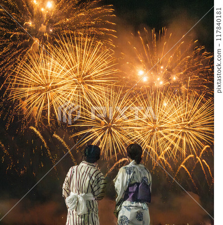 Two young women in yukata watching fireworks 117840181