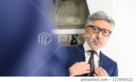 A man looks in the mirror and looks after himself 117840322