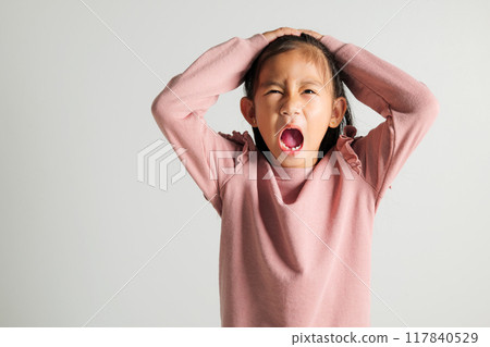Asian portrait young kid girl standing angry and mad raising fist frustrated and furious while shouting with anger isolated, studio shot on white background, kindergarten child not happy Asian portrait young kid girl standing angry and mad raising fist frustrated and furious while shouting with anger isolated, studio shot on white background, kindergarten child not happy 117840529