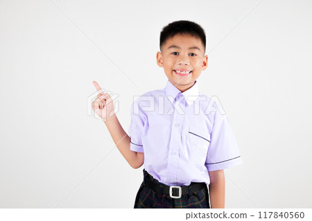 Portrait smile Asian little boy primary posing point finger to side away studio isolated white background, happy cute man kid wear school uniform plaid innocence and curiosity, back to school concept Portrait smile Asian little boy primary posing point finger to side away studio isolated white background, happy cute man kid wear school uniform plaid innocence and curiosity, back to school concept 117840560