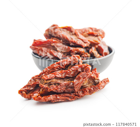 Sun dried red tomatoes isolated on white background. Sun dried red tomatoes isolated on white background. 117840571