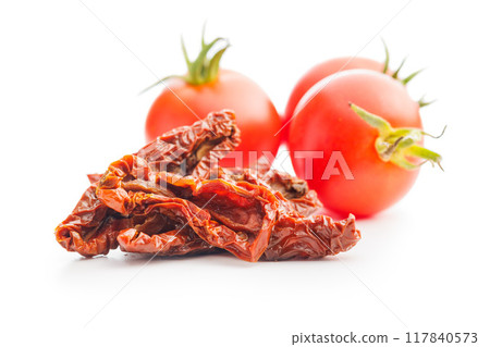 Sun dried red tomatoes isolated on white background. Sun dried red tomatoes isolated on white background. 117840573